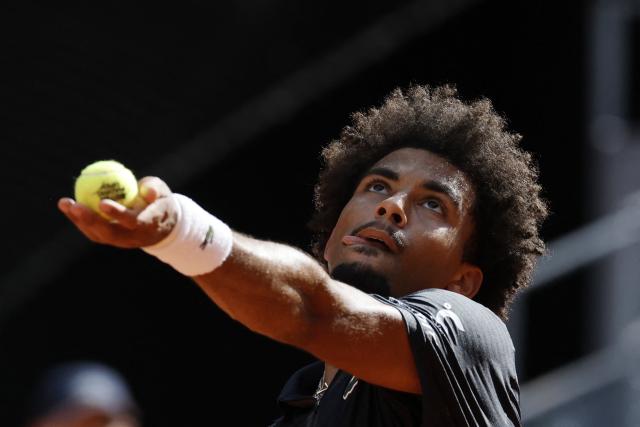 (FILES) France's Arthur Fils serves to Italy's Jannik Sinner during their 2026 ATP Tour Madrid Open tennis tournament semi-final singles match at the Caja Magica in Madrid, on May 1, 2026. France’s No. 1 Arthur Fils (world No. 19) will face Switzerland’s Stan Wawrinka, the 2015 champion who is playing his final professional season at the age of 41, in the first round of Roland Garros (24 May – 7 June), according to the draw held in Paris on May 21, 2026. (Photo by Oscar DEL POZO / AFP)