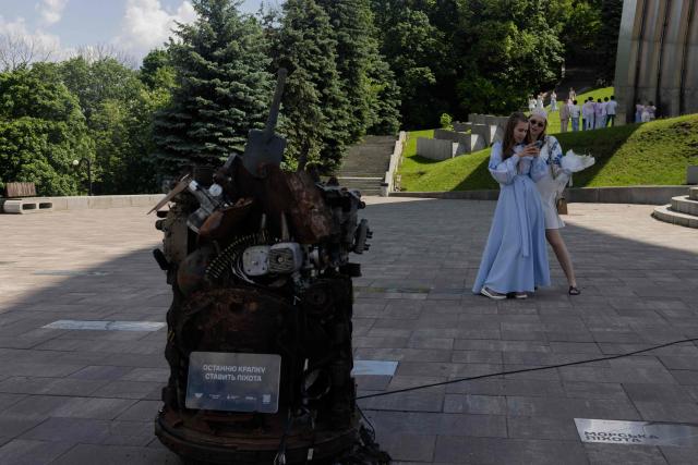 Girls wearing vyshyvankas take a photo on Vyshyvanka Day in Kyiv on May 21, 2026, amid the Russian invasion of Ukraine. (Photo by Tetiana DZHAFAROVA / AFP)