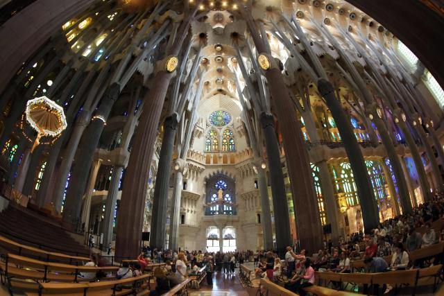 This general view of the Sagrada Familia basilica taken with a fisheye lens on May 21, 2026 shows the ceiling and columns of the nave in Barcelona. The Sagrada Familia basilica's central tower's cross crowns the world's tallest church at 172.5 meters, a temple conceived by Antoni Gaudi more than 140 years ago. (Photo by Thomas COEX / AFP)