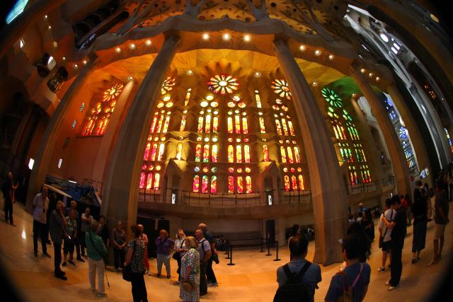 This general view of the Sagrada Familia basilica taken with a fisheye lens on May 21, 2026 shows the stained-glass windows and columns of the nave in Barcelona. The Sagrada Familia basilica's central tower's cross crowns the world's tallest church at 172.5 meters, a temple conceived by Antoni Gaudi more than 140 years ago. (Photo by Thomas COEX / AFP)