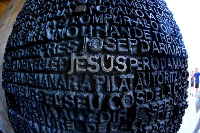 Words are seen on one of the doors of the Sagrada Familia basilica taken with a fisheye lens on May 21, 2026 in Barcelona. The Sagrada Familia basilica's central tower's cross crowns the world's tallest church at 172.5 meters, a temple conceived by Antoni Gaudi more than 140 years ago. (Photo by Thomas COEX / AFP)