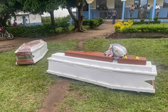 TOPSHOT - A general view of coffins placed on the grass at a hospital in Rwampara on May 21, 2026 after protesters set it on fire, after they were apparently denied access to the bodies of relatives killed in the latest Ebola outbreak. According to the WHO, the latest outbreak in the DRC, the 17th to hit the vast central African country of more than 100 million people, is already suspected of having caused 139 deaths out of nearly 600 probable cases.
Many of the cases have been recorded in the epidemic's epicentre in the DRC's northeastern Ituri province, many in hard-to-access areas plagued by the Congolese east's litany of armed groups. (Photo by Seros MUYISA / AFP)
