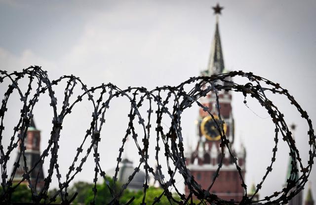 This photograph shows a view of the Kremlin taken on May 21, 2026 through the barbed wire of a municipal technical facility in Moscow. (Photo by Alexander NEMENOV / AFP)