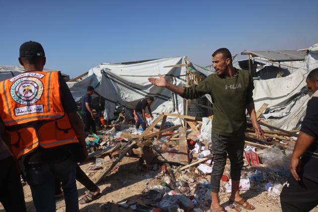 Displaced Palestinians inspect the site of an Israeli strike that targeted a food distribution tent in the Mawasi area of Khan Yunis, in the southern Gaza Strip on May 21, 2026. The war was sparked by Hamas's October 7, 2023 attack on Israel, which resulted in the deaths of 1,221 people. Israel's retaliatory assault on Gaza has killed at least 72,736 people, according to figures from the health ministry that the UN considers reliable. (Photo by Bashar Taleb / AFP)