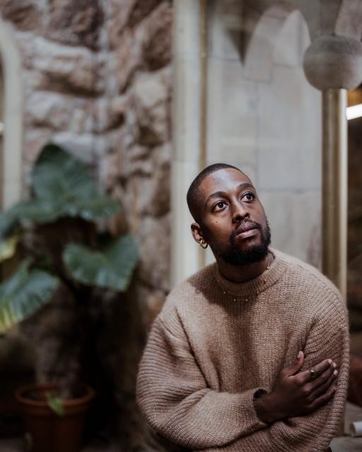 South African painter and multimedia artist Kamohelo Blessing Rooi, 25, poses for a portrait ahead of the opening of the 2026 edition of the RMB Latitudes Art Fair, at the  Shepstone Gardens in Johannesburg, on May 21, 2026. (Photo by MARCO LONGARI / AFP)
