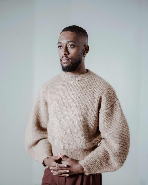 South African painter and multimedia artist Kamohelo Blessing Rooi, 25, poses for a portrait ahead of the opening of the 2026 edition of the RMB Latitudes Art Fair, at the  Shepstone Gardens in Johannesburg, on May 21, 2026. (Photo by MARCO LONGARI / AFP)