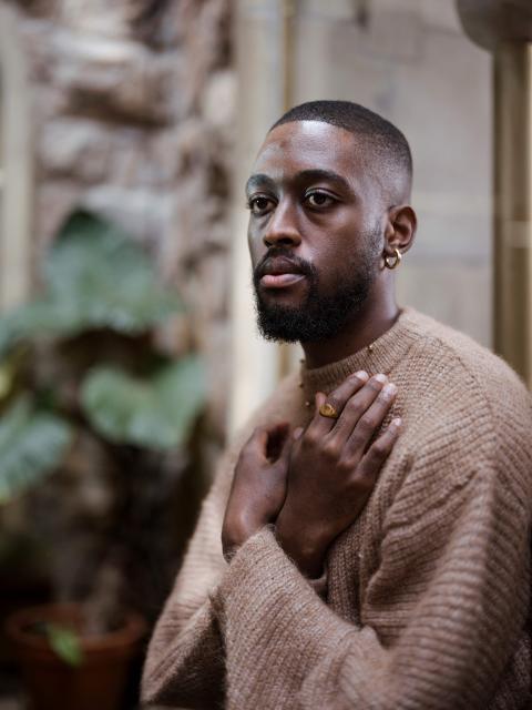 TOPSHOT - South African painter and multimedia artist Kamohelo Blessing Rooi, 25, poses for a portrait ahead of the opening of the 2026 edition of the RMB Latitudes Art Fair, at the  Shepstone Gardens in Johannesburg, on May 21, 2026. (Photo by MARCO LONGARI / AFP)
