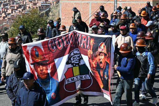 Miners take part in a march organized by the Bolivian Workers' Center (COB) from El Alto to La Paz, calling for the resignation of President Rodrigo Paz, on May 21, 2026. Bolivia's centre-right President Rodrigo Paz announced on May 20 that he will make changes to his cabinet to include social sectors, in an attempt to quell protests demanding his resignation just six months after taking office. (Photo by AIZAR RALDES / AFP)