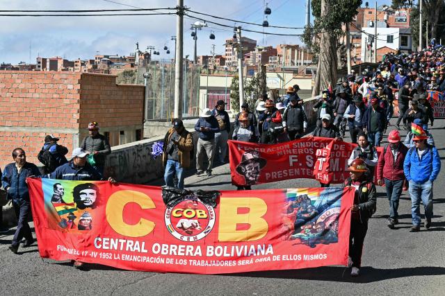 Protesters take part in a march organized by the Bolivian Workers' Center (COB) from El Alto to La Paz, calling for the resignation of President Rodrigo Paz, on May 21, 2026. Bolivia's centre-right President Rodrigo Paz announced on May 20 that he will make changes to his cabinet to include social sectors, in an attempt to quell protests demanding his resignation just six months after taking office. (Photo by AIZAR RALDES / AFP)