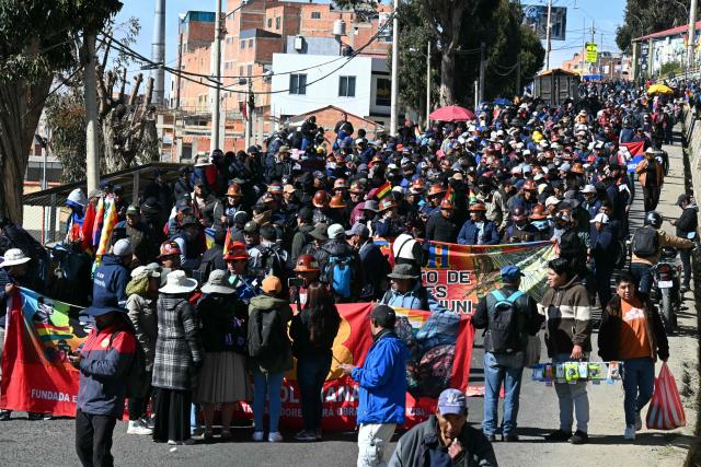 Protesters take part in a march organized by the Bolivian Workers' Center (COB) from El Alto to La Paz, calling for the resignation of President Rodrigo Paz, on May 21, 2026. Bolivia's centre-right President Rodrigo Paz announced on May 20 that he will make changes to his cabinet to include social sectors, in an attempt to quell protests demanding his resignation just six months after taking office. (Photo by AIZAR RALDES / AFP)