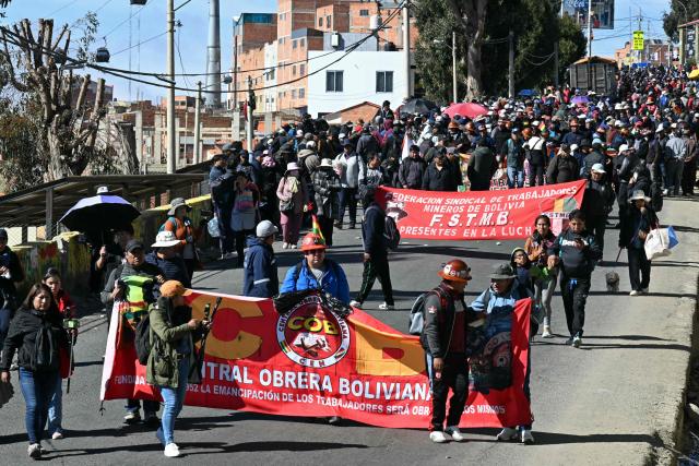 Protesters take part in a march organized by the Bolivian Workers' Center (COB) from El Alto to La Paz, calling for the resignation of President Rodrigo Paz, on May 21, 2026. Bolivia's centre-right President Rodrigo Paz announced on May 20 that he will make changes to his cabinet to include social sectors, in an attempt to quell protests demanding his resignation just six months after taking office. (Photo by AIZAR RALDES / AFP)