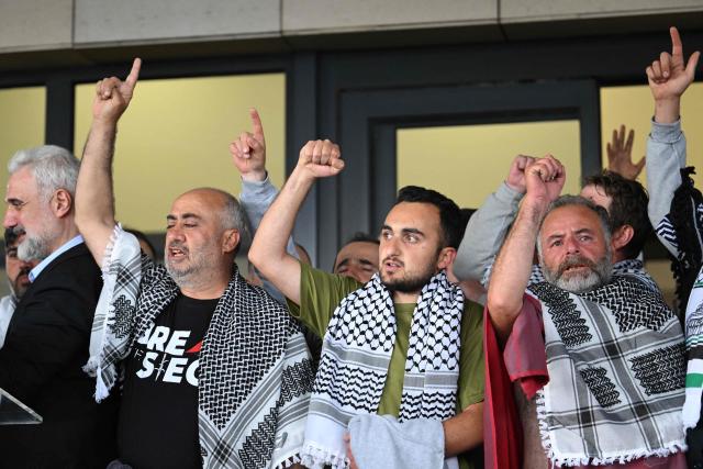 Members of the Global Sumud Flotilla headed for Gaza and arrested and deported by Israel pose outside a terminal following their arrival at Istanbul Airport on May 21, 2026. The first of hundreds of Gaza flotilla activists began arriving at Istanbul airport on may 21  after being arrested then deported from Israel, an AFP correspondent said. The 422 activists, who were flown from southern Israel on three planes chartered by Ankara, had been part of a fleet of around 50 vessels that set sail from southern Turkey on May 14 seeking to break Israel's blockade on Gaza, which was joined at sea by several others. (Photo by Ozan KOSE / AFP)