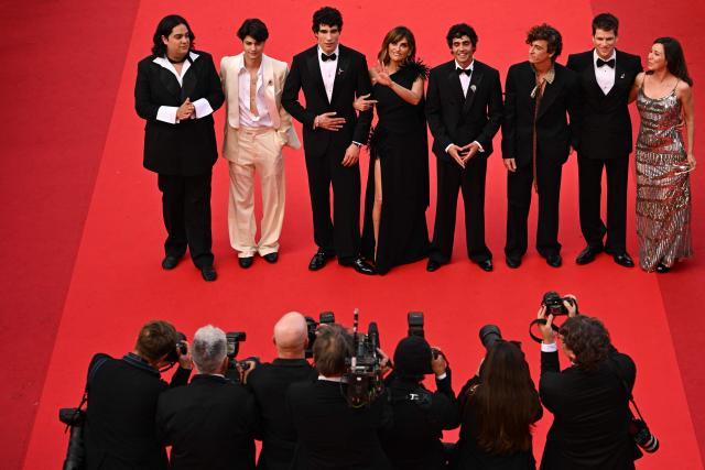 (From Top L) Venezuelan actor Carlos Gonzalez, actor Milo Quifes, Spanish director, screenwriter and producer Javier Calvo, Spanish actress Penelope Cruz, Spanish director, screenwriter and producer Javier Ambrossi, Spanish actor Alvaro Lafuente, Spanish actor Miguel Bernardeau, Spanish actress Lola Duenas arrive for the screening of the film "La Bola Negra" at the 79th edition of the Cannes Film Festival in Cannes, southern France on May 21, 2026. (Photo by Antonin THUILLIER / AFP)