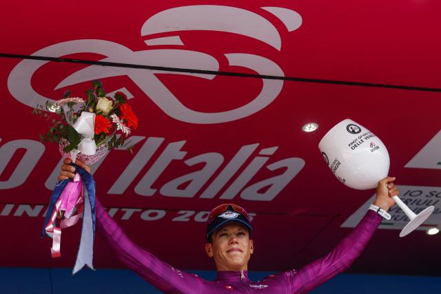 Soudal Quick-Step French rider Paul Magnier celebrates the best sprinter's purple jersey on the podium of the 12th stage of the Giro d'Italia 2026 - Tour of Italy cycling race between Imperia and Novi Ligure, Italy, on May 21, 2026. (Photo by Luca Bettini / AFP)