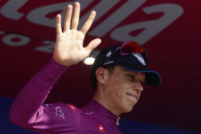 Soudal Quick-Step French rider Paul Magnier celebrates the best sprinter's purple jersey on the podium of the 12th stage of the Giro d'Italia 2026 - Tour of Italy cycling race between Imperia and Novi Ligure, Italy, on May 21, 2026. (Photo by Luca Bettini / AFP)