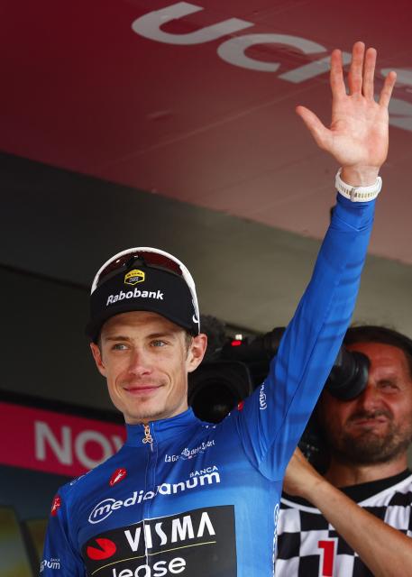 Team Visma Lease a Bike Danish rider Jonas Vingegaard celebrates with the best climber's blue jersey on the podium of the 12th stage of the Giro d'Italia 2026 - Tour of Italy cycling race between Imperia and Novi Ligure, Italy, on May 21, 2026. (Photo by Luca Bettini / AFP)