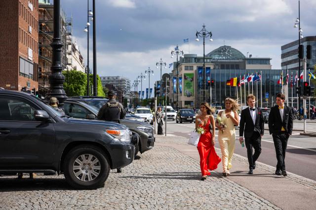 People walk past members of the security forces in central Helsingborg, Sweden, on May 21, 2026, ahead of the Meeting of NATO Ministers of Foreign Affairs taking place on May 21-22. (Photo by Jonathan NACKSTRAND / AFP)