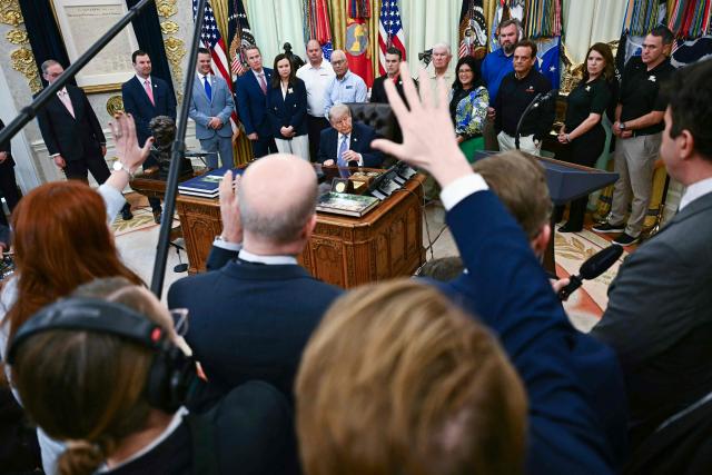 Reporters rise their hands to ask questions to US President Donald Trump during an announcement with Environmental Protection Agency (EPA) Administrator Lee Zeldin in the Oval Office of the White House in Washington, DC on May 21, 2026. (Photo by Kent NISHIMURA / AFP)