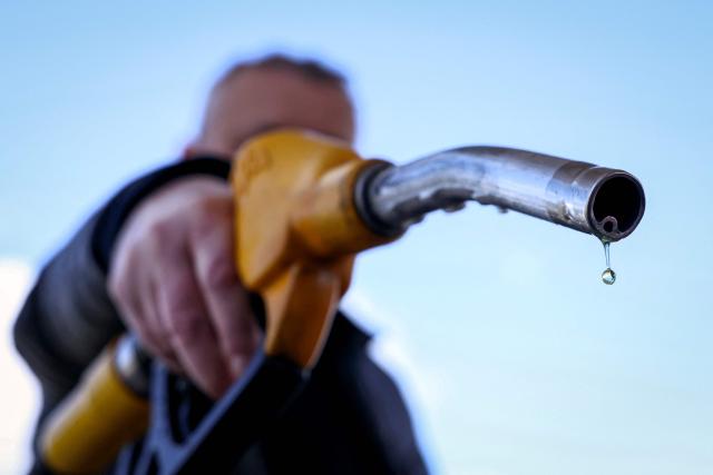 (FILES) A drop of petrol falls from the nozzle of a petrol pump at a petrol station in Vélizy-Villacoublay, near Paris, on March 9, 2026, as Oil prices soared peaking just short of $120 a barrel as the US-Israeli war against Iran continued into a second week, with Tehran launching fresh retaliatory strikes in the Gulf. France's Transport Minister announced on May 21, 2026 during a government press conference on the economic consequences of the war in the Middle East, that fuel subsidies for the road transport sector will be extended for a further three months from June 2026. (Photo by Alain JOCARD / AFP)