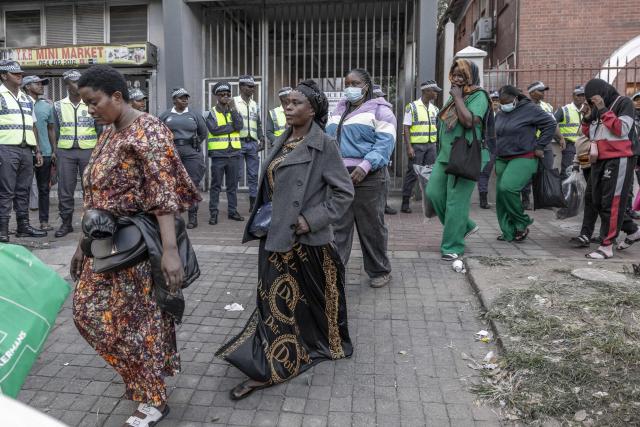 Foreign nationals who say they have no safe place to return to and are appealing for help from the South African government are seen being directed to a bus to be transported from the Diakonia Centre to the Home Affairs offices in Durban on May 21, 2026. The crowd, made up largely of refugees and foreign nationals had been sheltering at the station for up to two days, seeking police protection amid threats and intimidation. Their presence came against the backdrop of sporadic anti-illegal immigration protests that have unsettled parts of South Africa in recent weeks. (Photo by RAJESH JANTILAL / AFP)