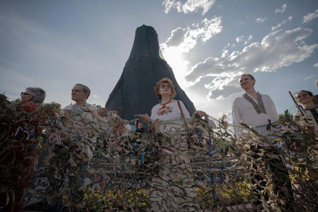 Local residents wearing "vyshyvankas", traditional embroidered Ukrainian shirts, hold camouflage nets on Vyshyvanka Day in Kharkiv, eastern Ukraine on May 21, 2026, amid the Russian invasion of Ukraine. (Photo by Ivan SAMOILOV / AFP)