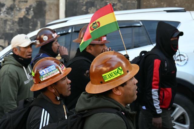 Miners take part in a march organized by the Bolivian Workers' Center (COB), calling for the resignation of President Rodrigo Paz, in La Paz on May 21, 2026. Bolivia's centre-right President Rodrigo Paz announced on May 20 that he will make changes to his cabinet to include social sectors, in an attempt to quell protests demanding his resignation just six months after taking office. (Photo by AIZAR RALDES / AFP)
