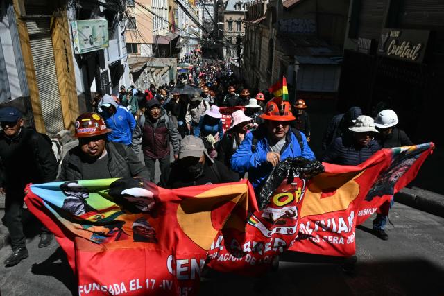 Protesters take part in a march organized by the Bolivian Workers' Center (COB), calling for the resignation of President Rodrigo Paz, in La Paz on May 21, 2026. Bolivia's centre-right President Rodrigo Paz announced on May 20 that he will make changes to his cabinet to include social sectors, in an attempt to quell protests demanding his resignation just six months after taking office. (Photo by AIZAR RALDES / AFP)