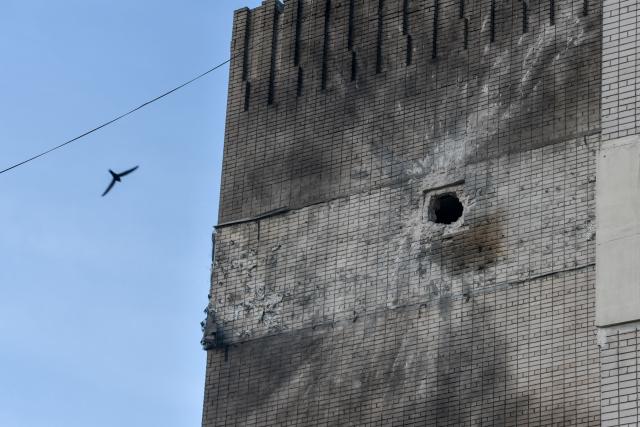 This photograph shows a damaged residential building following an air attack in Dnipro on May 21, 2026, amid the Russian invasion of Ukraine. (Photo by Mykola SYNELNYKOV / AFP)