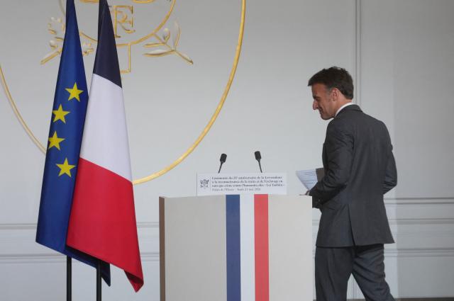 France's President Emmanuel Macron arrives on stage to deliver a speech during a ceremony marking the 25th anniversary of the law recognizing the slave trade and slavery as crimes against humanity at the Elysee Palace in Paris, on May 21, 2026. (Photo by Thibault Camus / POOL / AFP)