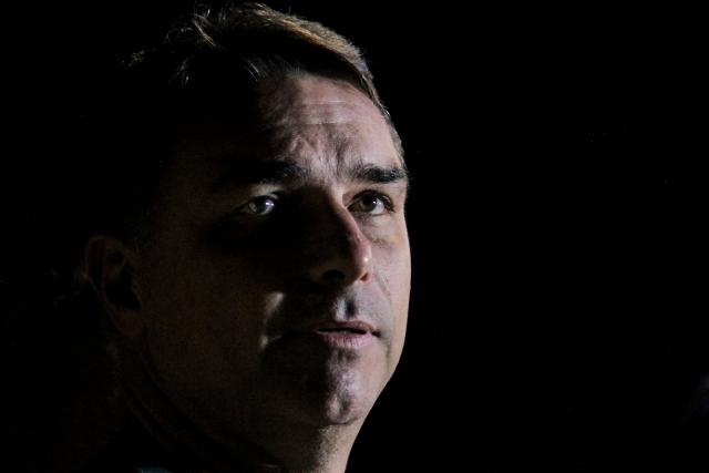 (FILES) Brazilian Senator Flavio Bolsonaro, son of former President Jair Bolsonaro (2019-2022), speaks to the press during the launch of his pre-candidacy for the presidency in Florianopolis, Santa Catarina state, Brazil, on May 9, 2026. When opinion polls appeared favorable, the scandal broke: Flavio Bolsonaro, the right-wing candidate in Brazil's October presidential election, had dealings with a banker jailed for alleged fraud, threatening to complicate his race against President Lula. The 45-year-old senator was chosen as the political heir by his father, former far-right president Jair Bolsonaro, who was convicted over an attempted coup and barred from running for office. (Photo by Vitor SOUZA / AFP)
