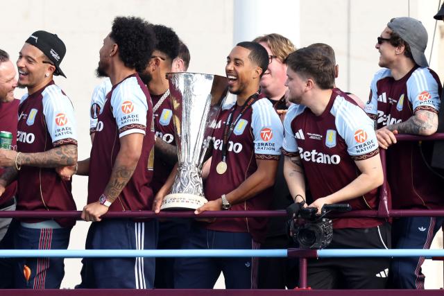 Aston Villa's Belgian midfielder #08 Youri Tielemans lifts the trophy on the bus during the team's trophy parade, the day after their team won the Europa League, in Birmingham, central England on May 21, 2026. Aston Villa's win in the Europa League puts an end to their 30-year trophy drought. (Photo by Darren Staples / AFP)