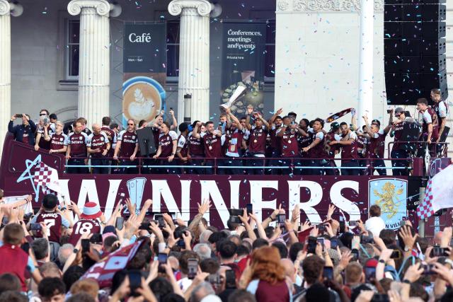 Aston Villa players celebrate from the bus during the team's trophy parade, the day after their team won the Europa League, in Birmingham, central England on May 21, 2026. Aston Villa's win in the Europa League puts an end to their 30-year trophy drought. (Photo by Darren Staples / AFP)