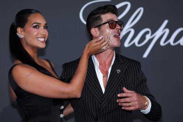 US singer Robin Thicke and his spouse US model April Love Geary attend the annual American Foundation for AIDS Research amfAR Gala Cannes 2026 at the Hotel du Cap-Eden-Roc in Cap d'Antibes, southern France, on the sidelines of the 79th edition of the Cannes Film Festival on May 21, 2026. (Photo by Julie SEBADELHA / AFP)