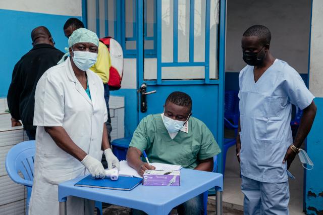 Doctors from CBCA Virunga hospital prepares to check a visitors temperature at a screening checkpoint set up at the hospital entrance as part of Ebola prevention measures in Goma, on May 21, 2026. An Ebola outbreak in the Democratic Republic of Congo has spread to eastern South Kivu province in an area under the control of the Rwanda-backed M23 militia, the group's spokesman said Thursday, heightening fears of the deadly disease's growing reach.
Efforts to get a grip on the latest outbreak of the highly contagious haemorrhagic fever, which the World Health Organization has declared an international emergency, have been hampered by the DRC's long-running conflicts, including between the Congolese army and the M23. Having seized swathes of land in the mineral-rich east with Rwanda's help, the M23 has installed a parallel administration to the Congolese government in areas under its control. (Photo by Jospin Mwisha / AFP)