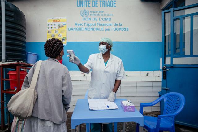 A doctor from CBCA Virunga hospital checks a visitors temperature at a screening checkpoint set up at the hospital entrance as part of Ebola prevention measures in Goma, on May 21, 2026. An Ebola outbreak in the Democratic Republic of Congo has spread to eastern South Kivu province in an area under the control of the Rwanda-backed M23 militia, the group's spokesman said Thursday, heightening fears of the deadly disease's growing reach.
Efforts to get a grip on the latest outbreak of the highly contagious haemorrhagic fever, which the World Health Organization has declared an international emergency, have been hampered by the DRC's long-running conflicts, including between the Congolese army and the M23. Having seized swathes of land in the mineral-rich east with Rwanda's help, the M23 has installed a parallel administration to the Congolese government in areas under its control. (Photo by Jospin Mwisha / AFP)