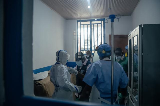 Dr Abdou Sebushishe (2nd L) Senior Health Advisor at International Medical Corps, guides and shows CBCA Virunga doctors how to properly put on single-use personal protective equipment provided by International Medical Corps, as part of support for Ebola virus disease prevention measures in Goma, on May 21, 2026. An Ebola outbreak in the Democratic Republic of Congo has spread to eastern South Kivu province in an area under the control of the Rwanda-backed M23 militia, the group's spokesman said Thursday, heightening fears of the deadly disease's growing reach.
Efforts to get a grip on the latest outbreak of the highly contagious haemorrhagic fever, which the World Health Organization has declared an international emergency, have been hampered by the DRC's long-running conflicts, including between the Congolese army and the M23. Having seized swathes of land in the mineral-rich east with Rwanda's help, the M23 has installed a parallel administration to the Congolese government in areas under its control. (Photo by Jospin Mwisha / AFP)