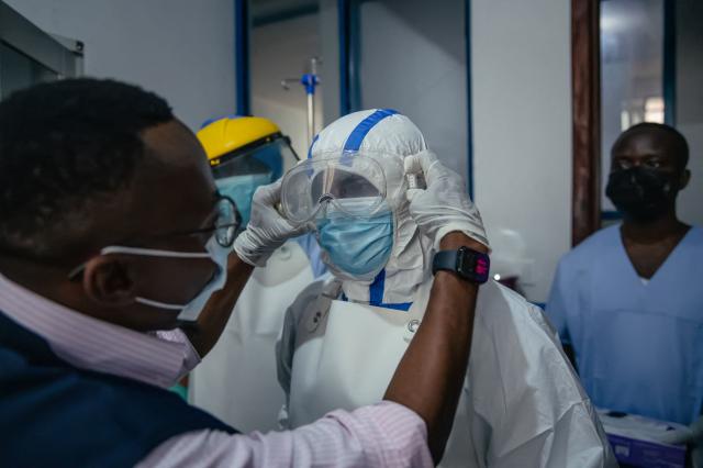 Dr Abdou Sebushishe (L) Senior Health Advisor at International Medical Corps, guides and shows CBCA Virunga doctors how to properly put on single-use personal protective equipment provided by International Medical Corps, as part of support for Ebola virus disease prevention measures in Goma, on May 21, 2026. An Ebola outbreak in the Democratic Republic of Congo has spread to eastern South Kivu province in an area under the control of the Rwanda-backed M23 militia, the group's spokesman said Thursday, heightening fears of the deadly disease's growing reach.
Efforts to get a grip on the latest outbreak of the highly contagious haemorrhagic fever, which the World Health Organization has declared an international emergency, have been hampered by the DRC's long-running conflicts, including between the Congolese army and the M23. Having seized swathes of land in the mineral-rich east with Rwanda's help, the M23 has installed a parallel administration to the Congolese government in areas under its control. (Photo by Jospin Mwisha / AFP)