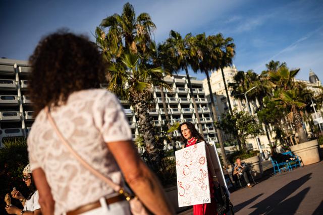 Pedestrians walk along the Boulevard de la Croisette on the sidelines of the 79th edition of the Cannes Film Festival in Cannes, southern France on May 21, 2026. (Photo by SAMEER AL-DOUMY / AFP)