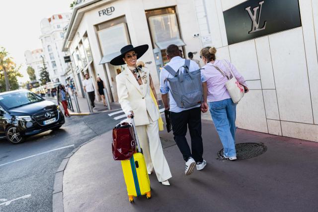 Pedestrians walk along the Boulevard de la Croisette on the sidelines of the 79th edition of the Cannes Film Festival in Cannes, southern France on May 21, 2026. (Photo by SAMEER AL-DOUMY / AFP)