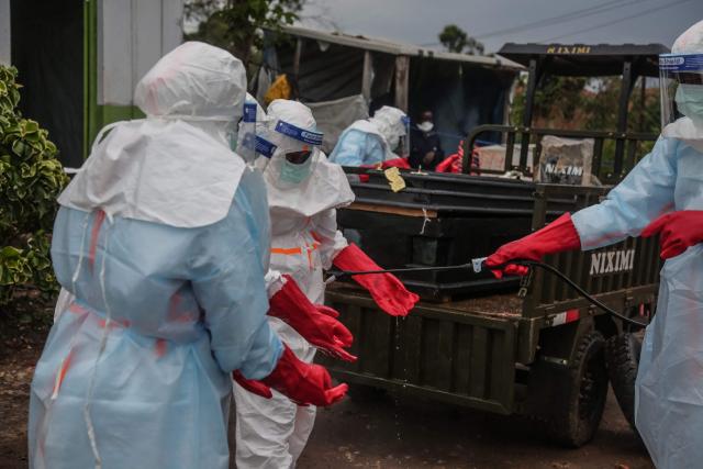 Medical staff wearing personal protective equipment (PPE) are sprayed with disinfectant after loading the body of a patient deceased at the hospital in Rwampara on May 21, 2026. According to the WHO, the latest outbreak in the DRC, the 17th to hit the vast central African country of more than 100 million people, is already suspected of having caused 139 deaths out of nearly 600 probable cases.
Many of the cases have been recorded in the epidemic's epicentre in the DRC's northeastern Ituri province, many in hard-to-access areas plagued by the Congolese east's litany of armed groups. (Photo by Seros MUYISA / AFP)