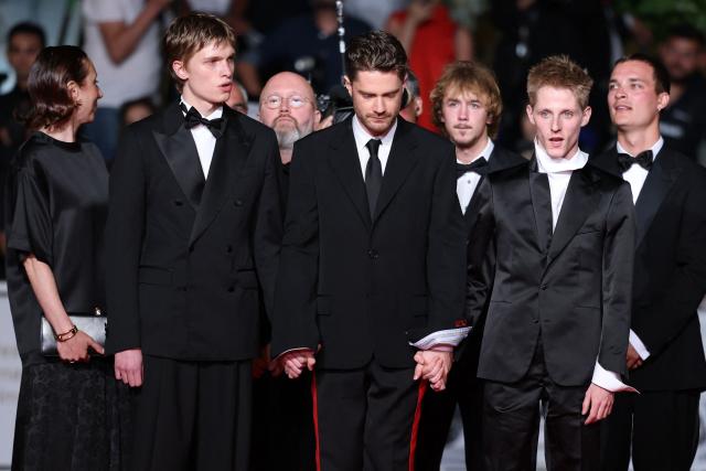 (From L) Belgian actor Emmanuel Macchia, Belgian director Lukas Dhont, French actor Valentin Campagne arrive for the screening of the film "Coward" at the 79th edition of the Cannes Film Festival in Cannes, southern France on May 21, 2026. (Photo by Sameer AL-DOUMY / AFP)