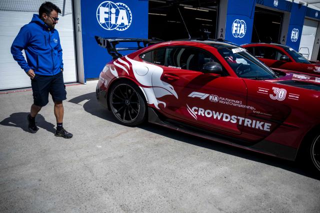 A man looks at the safety car before the F1 races at the Circuit Gilles-Villeneuve in Montreal, Quebec, Canada, on May 21, 2026. (Photo by ANDREJ IVANOV / AFP)