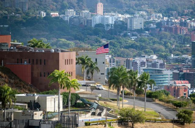 (FILES) The US flag flutters at the US embassy in Caracas on March 14, 2026, ten days after the restoration of diplomatic relations following the capture of ousted leader Nicolas Maduro in a US military raid. Venezuela has authorized the United States to conduct an evacuation drill on May 23 at its embassy in Caracas, which will include two U.S. aircraft flying over the capital, Venezuelan Foreign Minister Yvan Gil announced on May 21, 2026. (Photo by Maryorin Mendez / AFP)