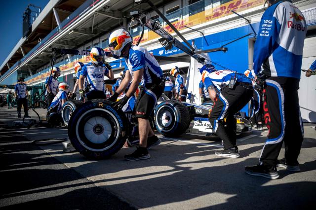 The Red Bull pit crew demonstrate tire changing on Racing Bulls' New Zealand driver Liam Lawson's car in front of some F1 fans before the F1 races at the Circuit Gilles-Villeneuve in Montreal, Quebec, Canada, on May 21, 2026. (Photo by ANDREJ IVANOV / AFP)
