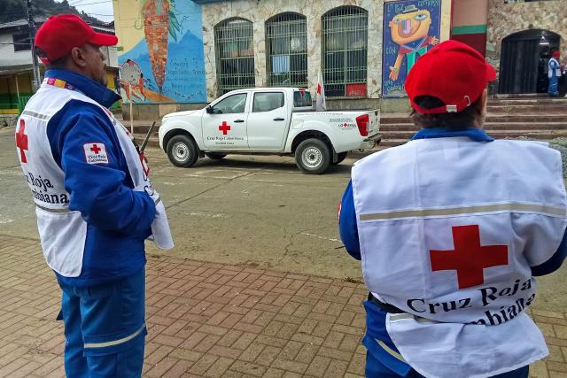 Members of the Colombian Red Cross stand next to a pickup truck in Silvia, Cauca department, Colombia on May 21, 2026. A land dispute between two indigenous groups left three people dead and 44 injured in a troubled region of Colombia on May 21, 2026, a governor reported. (Photo by Francisco Calderon / AFP)