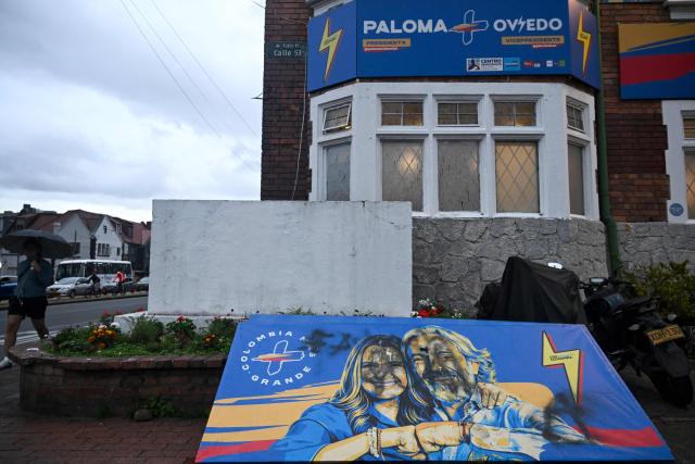 A view of a vandalised banner depicting Colombia's presidential candidate Paloma Valencia and vice-presidential candidate Juan Daniel Oviedo, from the Centro Democratico party, outside the campaign headquarters in Bogota on May 21, 2026. Colombia will hold presidential elections on May 31. (Photo by Raul ARBOLEDA / AFP)
