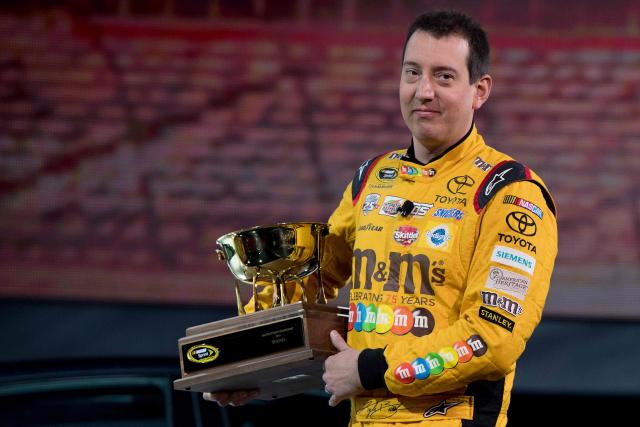 (FILES) 2015 NASCAR Sprint Cup Series Champion Kyle Busch carries the 2016 NASCAR Manufacturers Trophy at the Toyota press conference during the 2017 North American International Auto Show in Detroit, Michigan, on January 9, 2017. NASCAR star Kyle Busch, a two-time Cup series champion regarded as one of the sport's greatest ever drivers, died May 21, 2026 aged 41, his family confirmed in a joint statement. He was in his 22nd season in NASCAR's top division and had been hospitalized earlier Thursday with an undisclosed but "severe illness". (Photo by JIM WATSON / AFP)