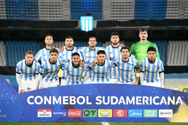 Racing players pose for pictures before the Copa Sudamericana group stage football match between Argentina's Racing Club and Venezuela's Caracas FC at Presidente Peron 'El Cilindro' stadium in Avellaneda, Buenos Aires province, Argentina on May 21, 2026. (Photo by Luis ROBAYO / AFP)