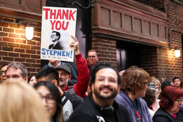 People wait in hopes to see Stephen Colbert outside the Ed Sullivan Theater after the taping of the final episode of the "The Late Show" in New York, on May 21, 2026. "The Late Show" frontman Stephen Colbert will host the final edition of the 33-year-old US cultural institution on May 21, after it was cancelled by CBS as the network courted President Donald Trump. The show, which Colbert has hosted since 2015, was axed after he mocked the broadcaster for a $16 million settlement with Trump for allegedly "maliciously" editing an interview with his Democratic election rival Kamala Harris. (Photo by CHARLY TRIBALLEAU / AFP)