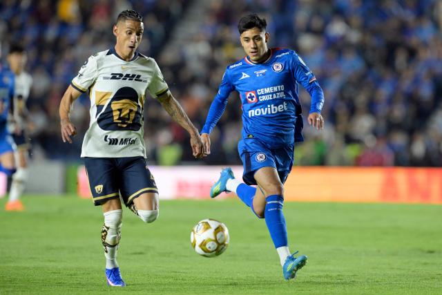 Pumas' midfielder #21 Uriel Antuna and Cruz Azul's defender #03 Omar Campos fight for the ball during the Liga MX Clausura final first-leg football match between Cruz Azul and Pumas at the Ciudad de los Deportes Stadium in Mexico City on May 21, 2026. (Photo by Alfredo ESTRELLA / AFP)